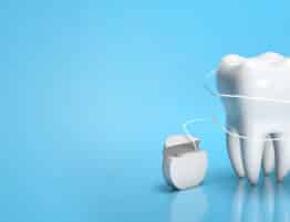 Dental floss. Flossing your teeth. Tooth and dental floss on a blue background. Copy space for text. 3d render.